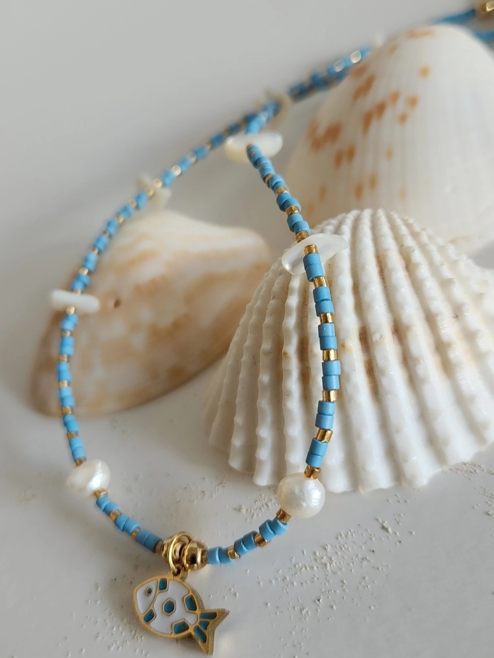 Turquoise Beaded Necklace with Gold Accents and Fish Charm.